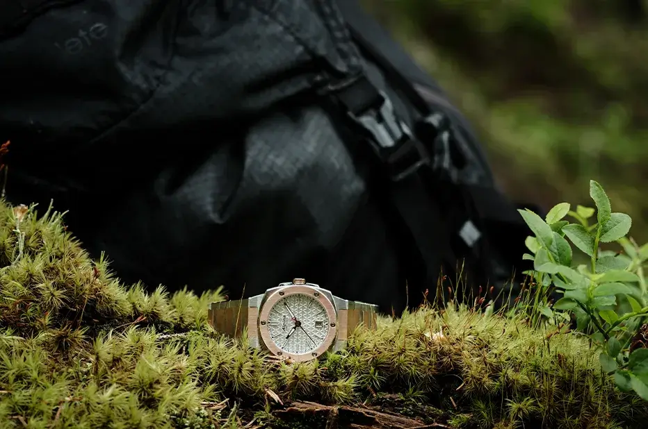 Zegarek damski Alpina Alpiner Extreme Quartz AL-220S2AE2B w naturalnym terenie – stylowy model bicolor na tle plecaka i mchu