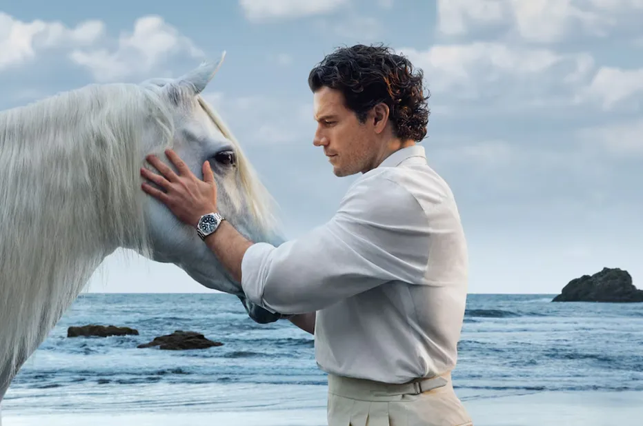 Henry Cavill w kampanii Longines HydroConquest głaszczący białego konia na Teneryfie