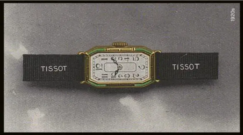 Prostokątny zegarek damski Tissot z lat 20. XX wieku w stylu Art Déco z kopertą w kolorze złota i zielonym detalem