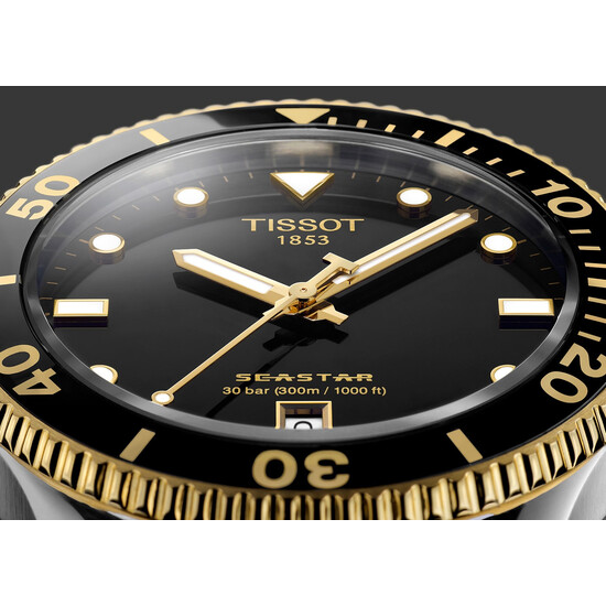 Czarna tarcza ze złotymi akcentami Tissot